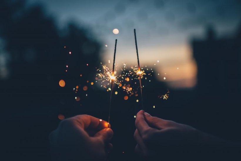 Sparklers held at dusk